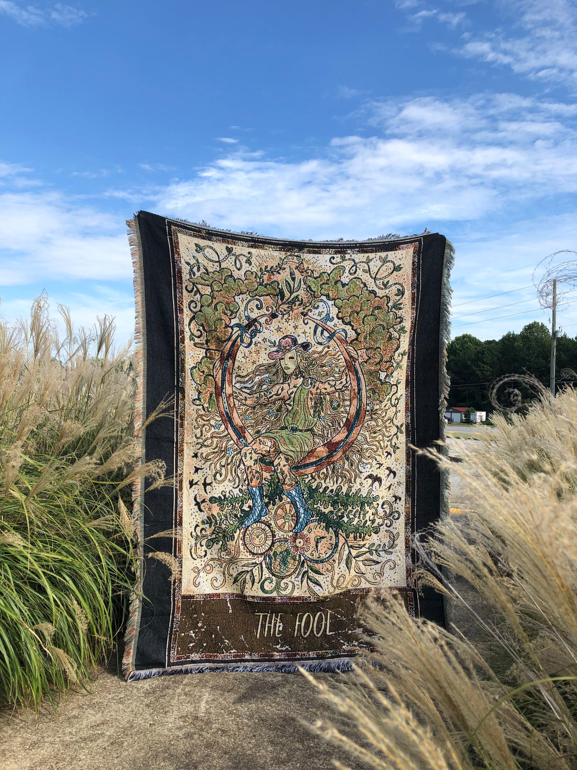 The Fool - Tarot Card Throw Blanket/ Woven Tapestry holding up in middle of a field