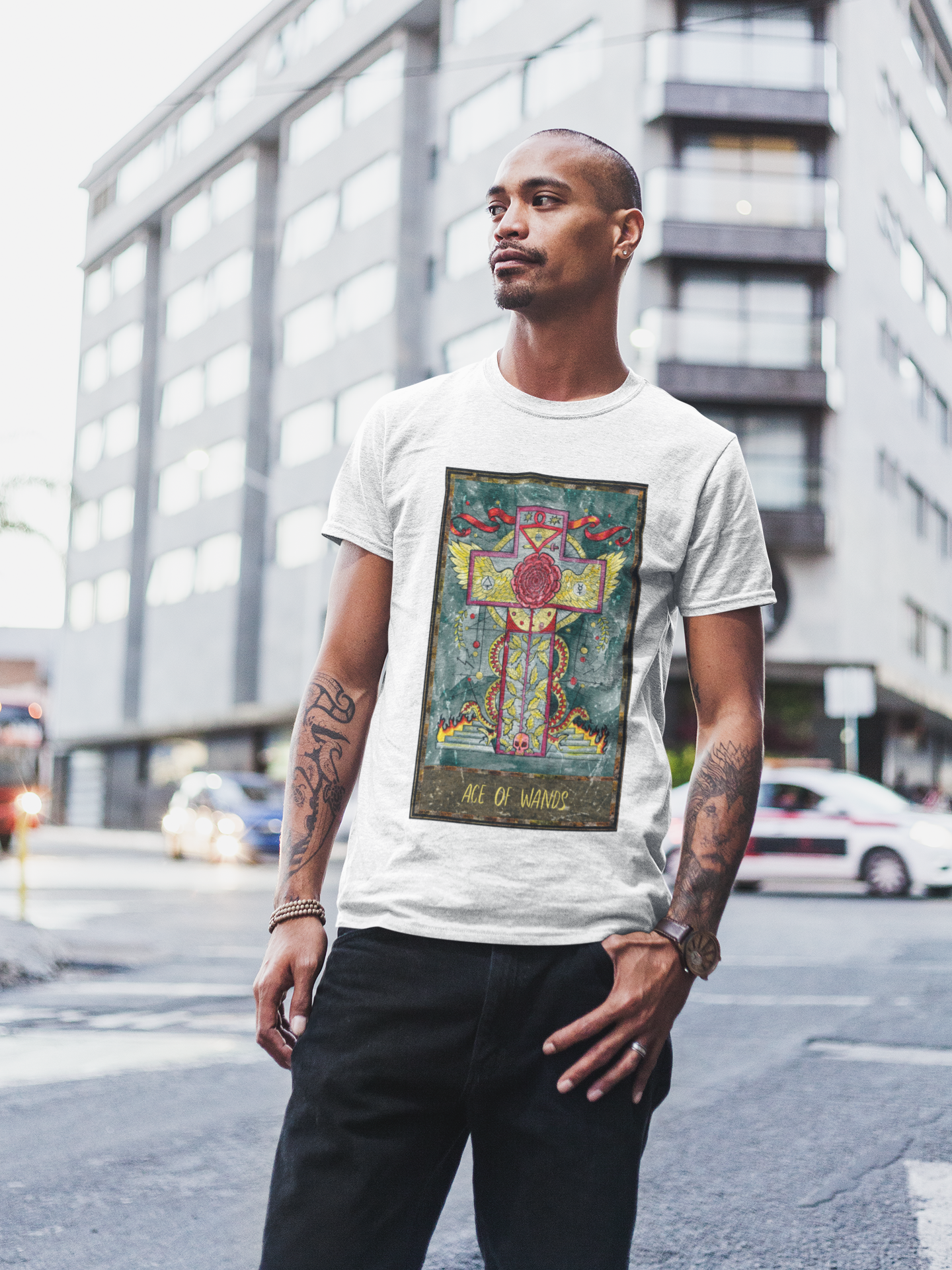 A man wearing a white Ace of Wands Tarot Card T-shirt, and black jeans