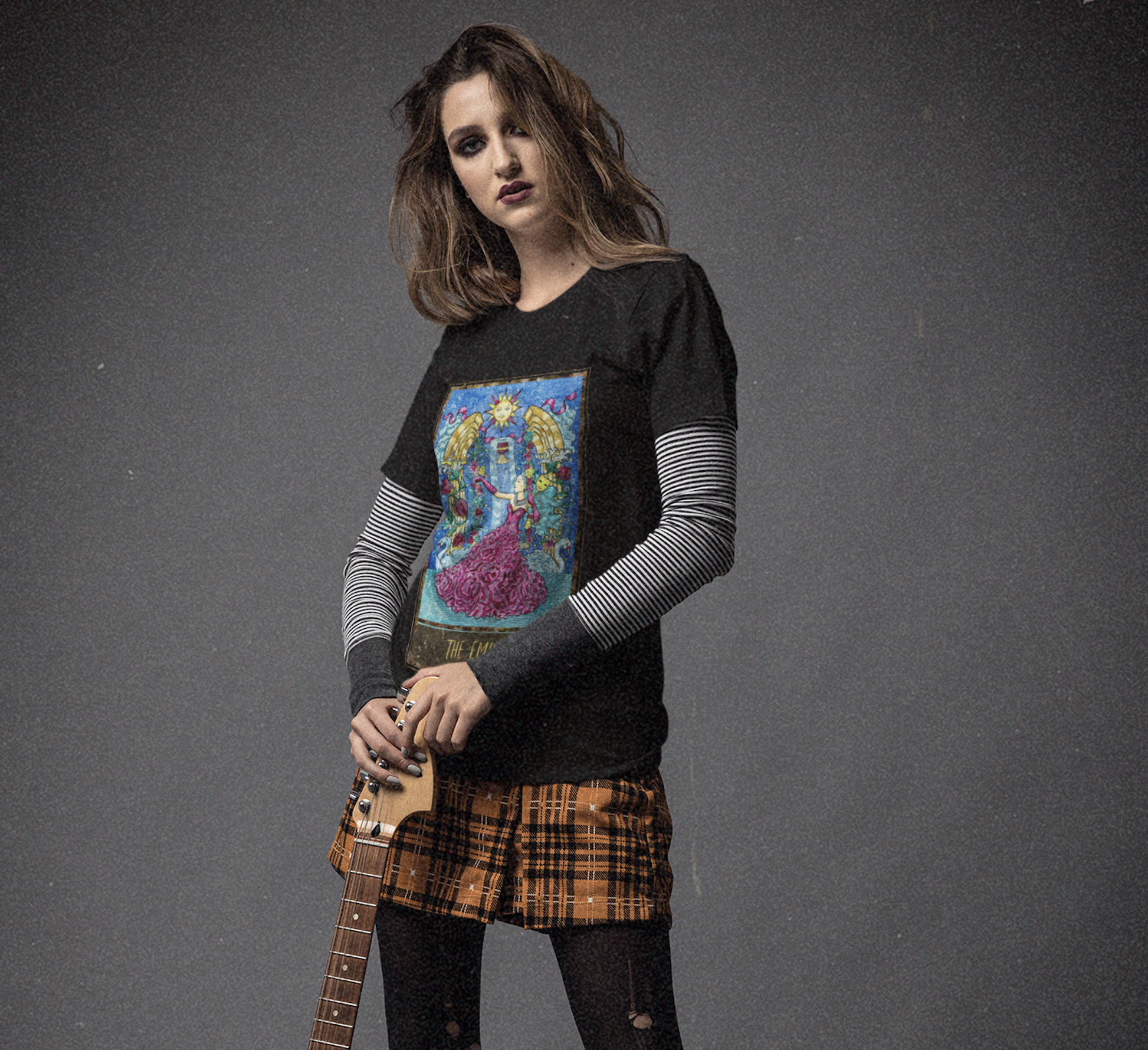 A woman wearing a black The Empress Tarot Card T-Shirt posing with an electric guitar