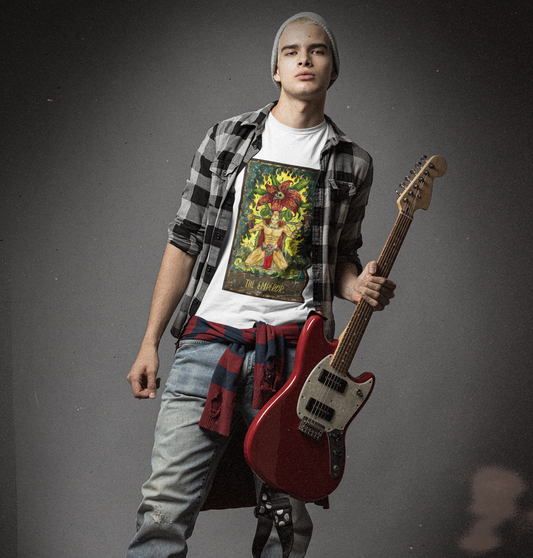 A man posing with a guitar wearing a white The Emperor Tarot Card T-shirt with a checkered collar shirt, and jeans