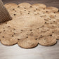 Circle Seagrass Rug on a wooden floor