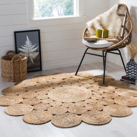 Circle Seagrass Rug with a basket, picture, a chair with decorations, a vase and books in the background