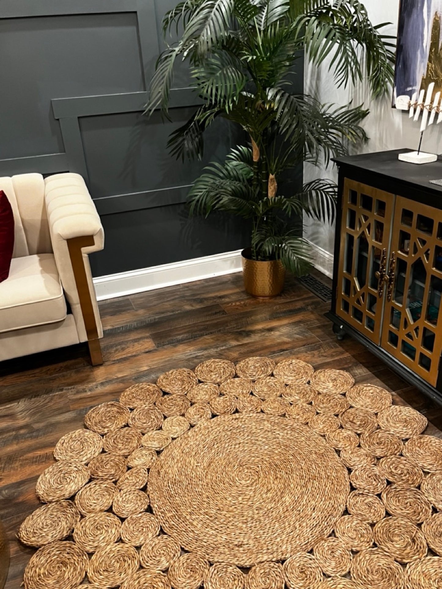 Circle Seagrass Rug next to a drawer, a plant and the sofa