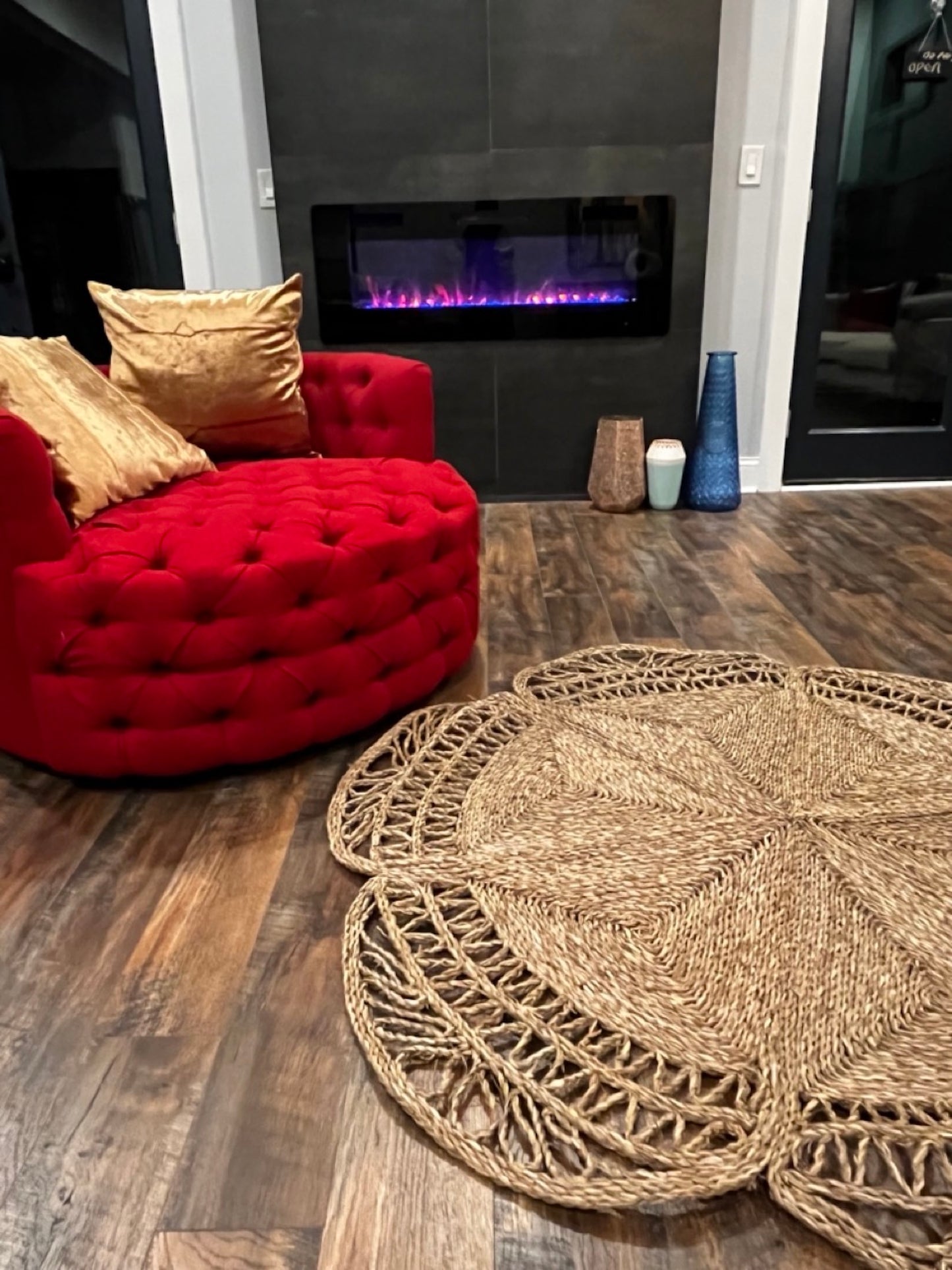 A Flower Seagrass Rug next to the red chair