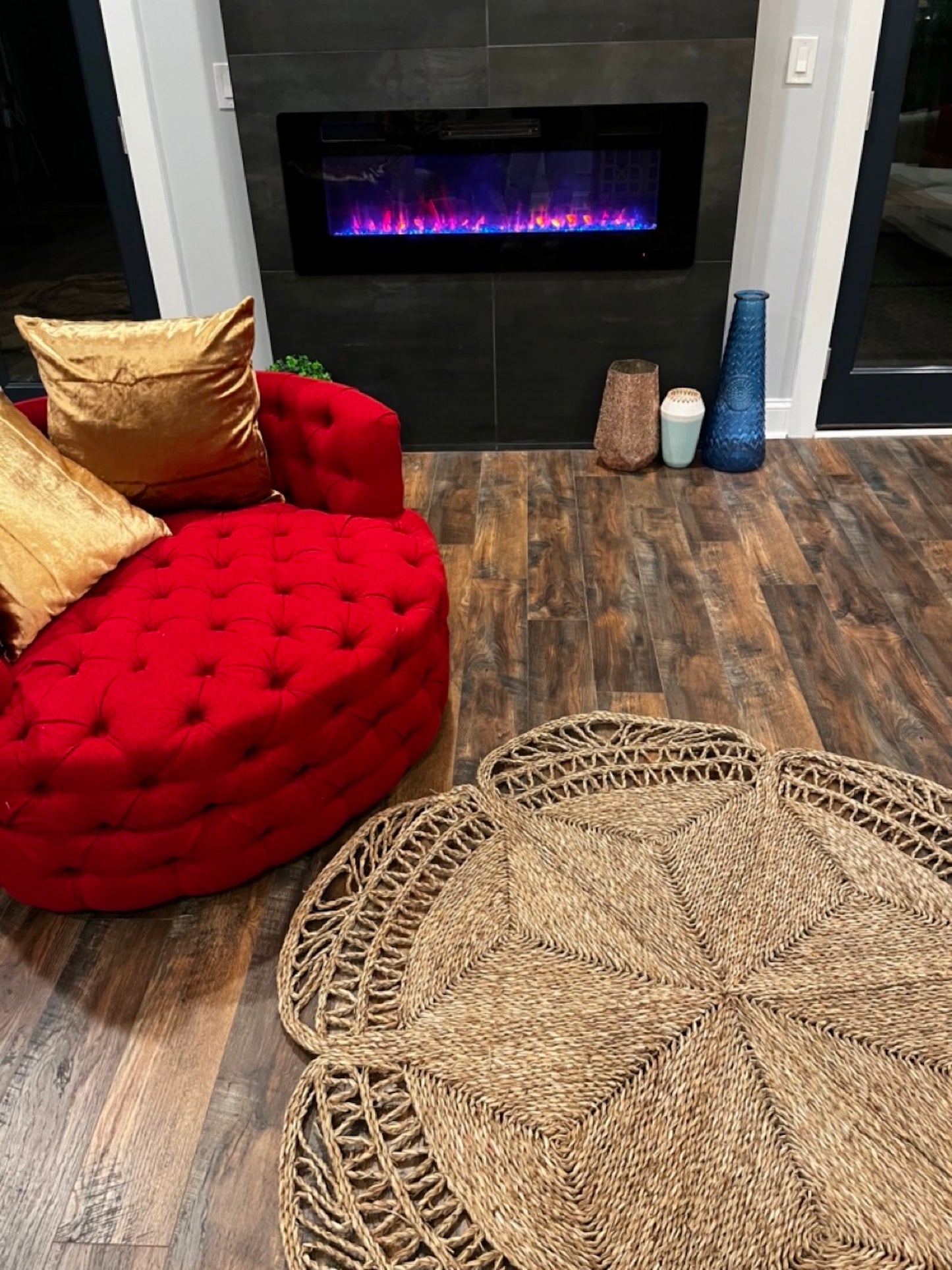 Flower Seagrass Rug in the living room next to a red chair