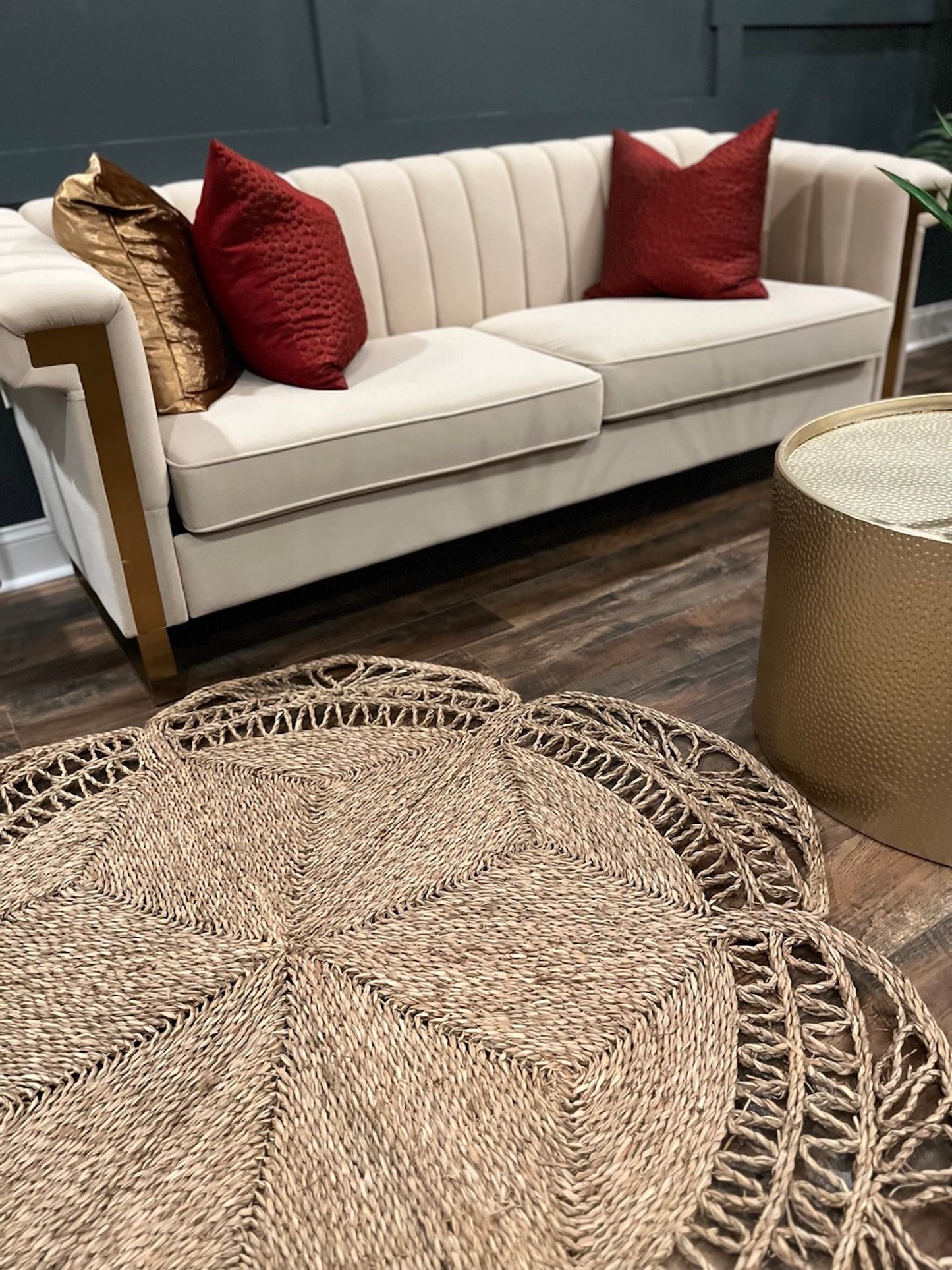 Flower Seagrass Rug in the living room in front of the sofa and a round gold table