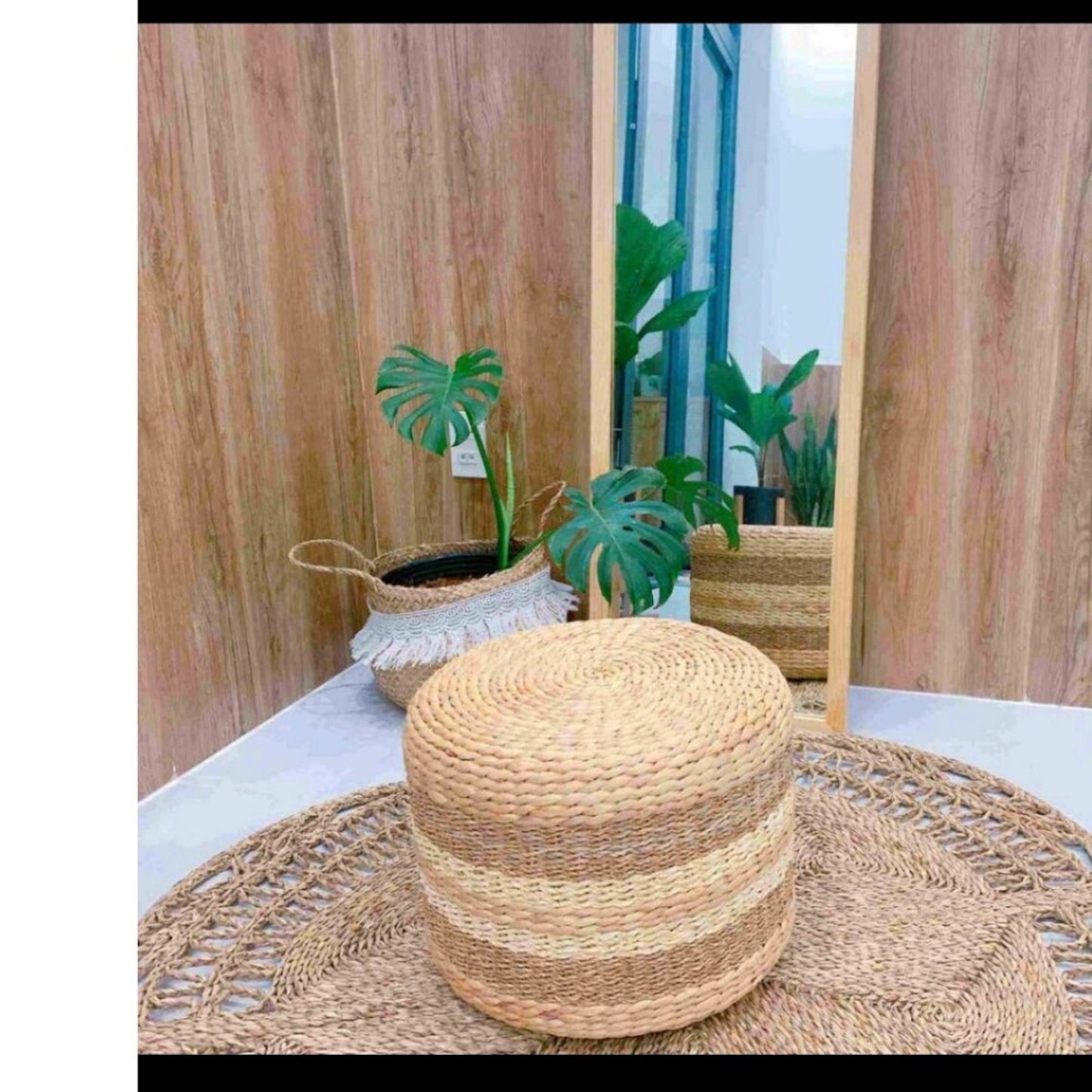 Flower Seagrass Rug with a chair on top in front of a mirror 