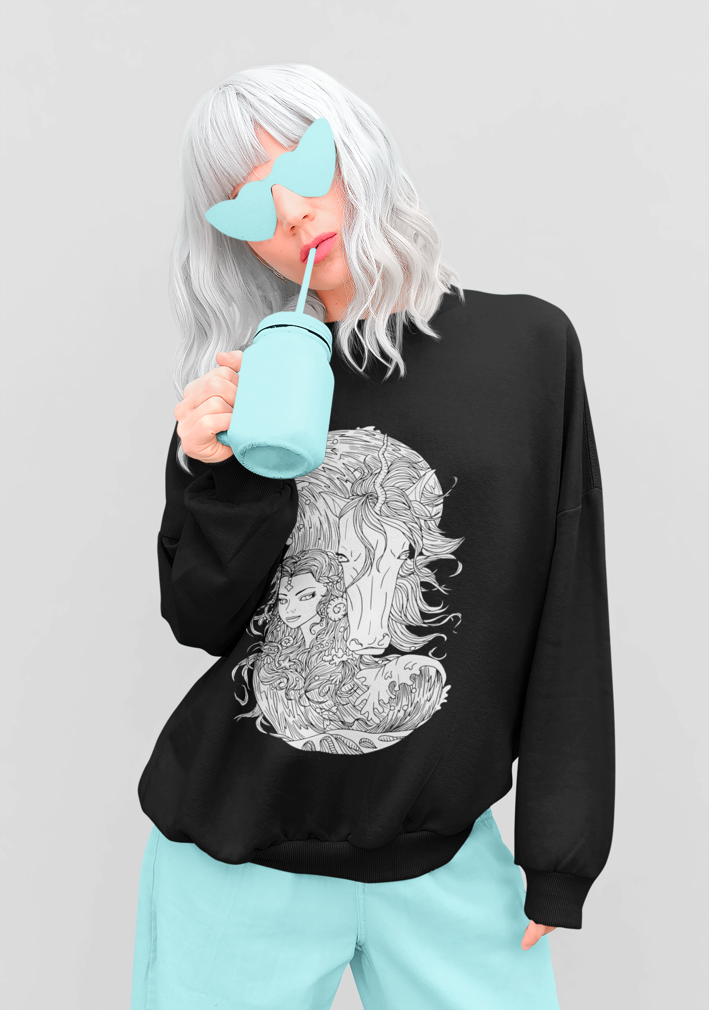 A woman drinking from a straw wearing a black Line Art BW Ice Blue Princess and Magic Unicorn Sweatshirt