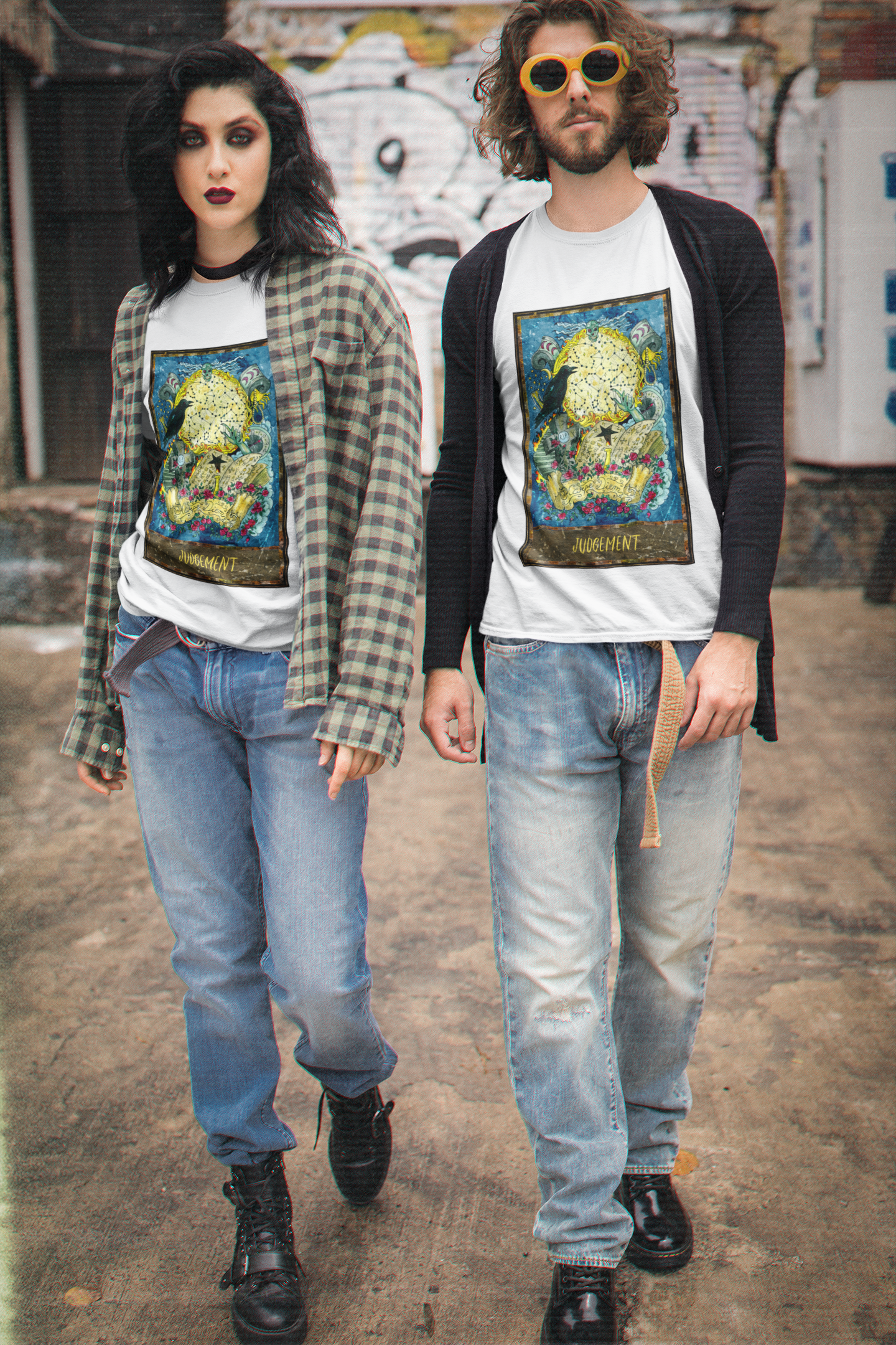 A couple wearing white Judgement - Tarot Card T-Shirts inside of cardigan and shirt, blue jeans and black boots