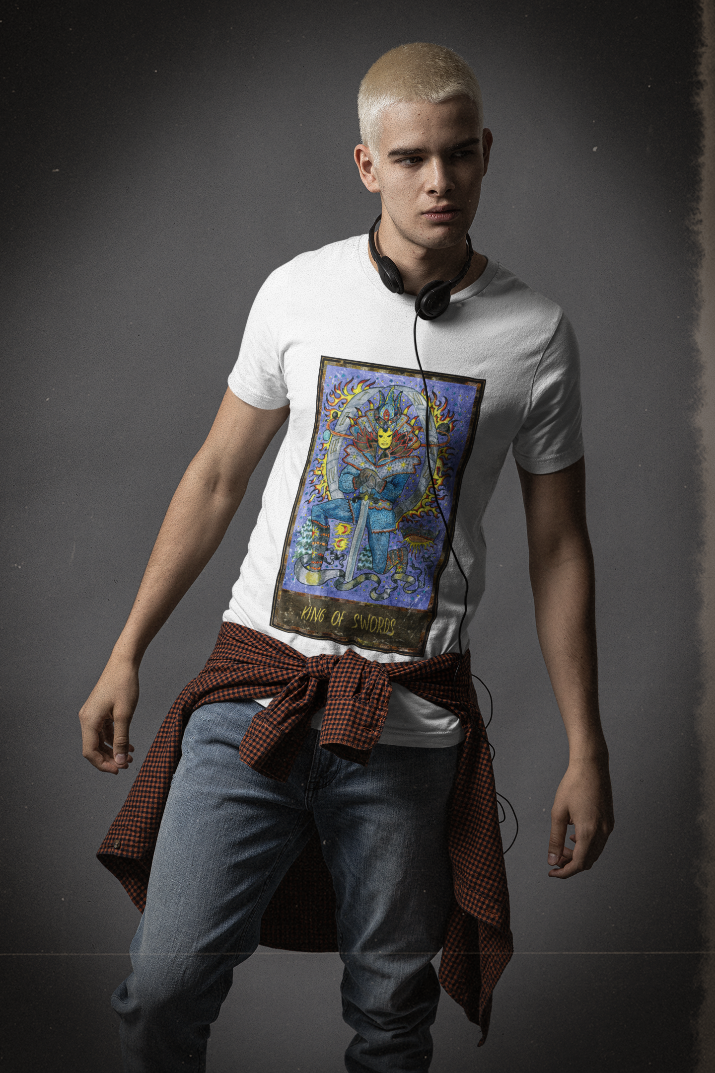 A man wearing a white King of Swords Tarot Card T-Shirt, blue jeans with a shirt tying around his waist