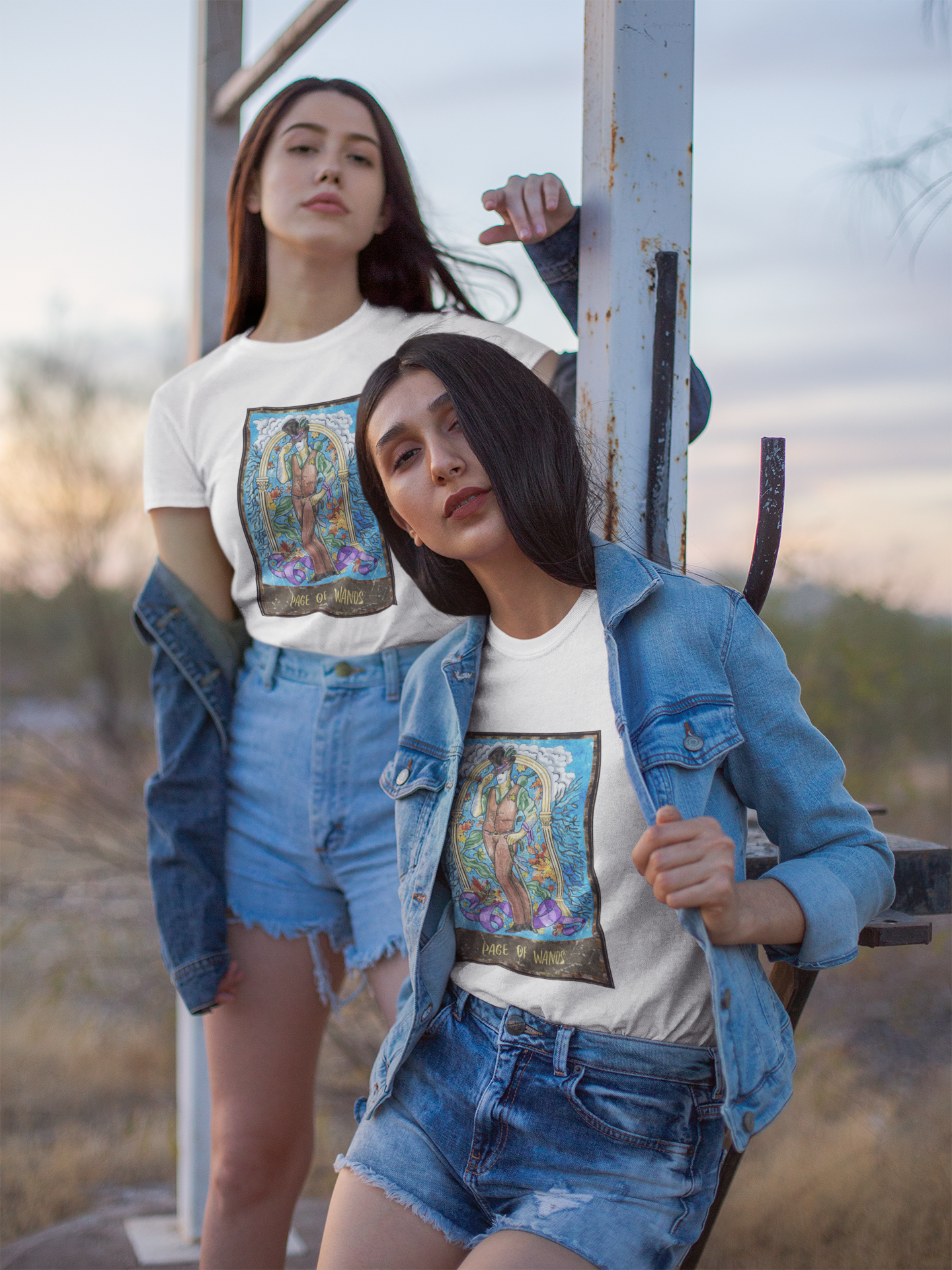 Two young girls wearing white Page of Wands Tarot Card T-shirts and denim outfits