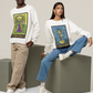 A woman wearing a white Queen of Cups Tarot Card Sweatshirt with blue jeans, and white shoes. Standing next to her is a man wearing a white King of Cups Tarot Card Sweatshirt with beige pants and white shoes