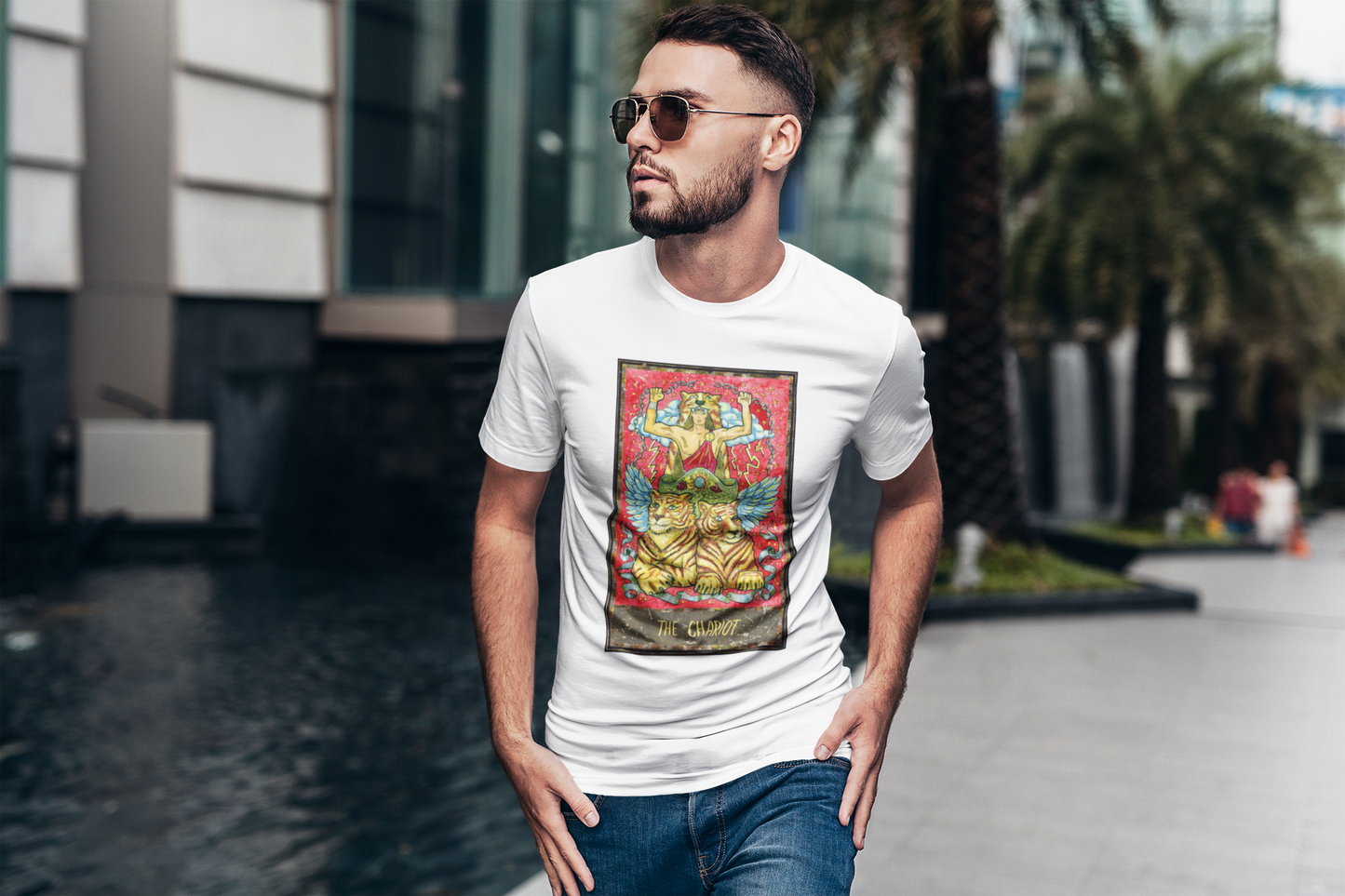 A man with sunglasses walking on the street wearing a white The Chariot Tarot Card T-shirt