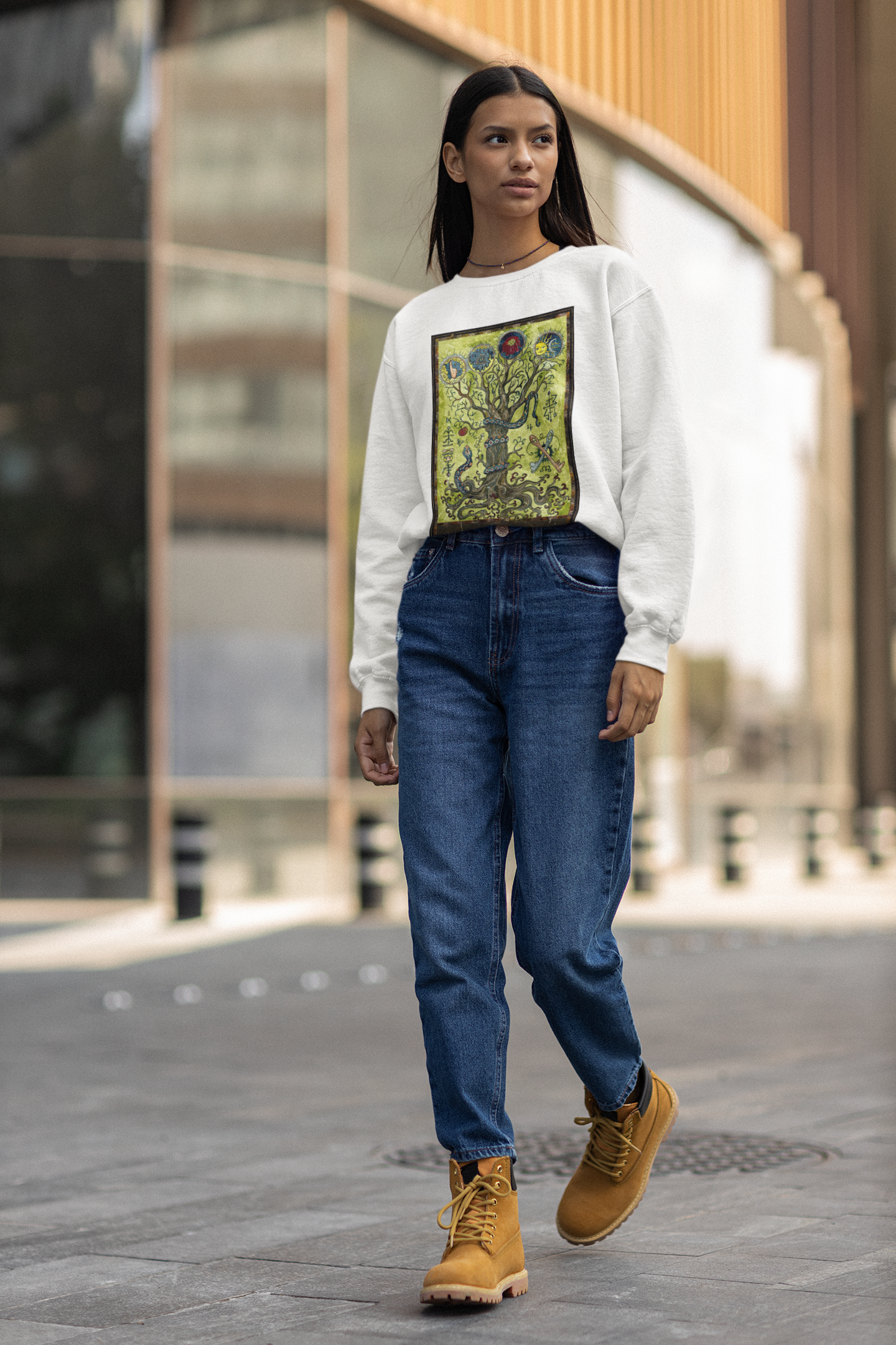 A long haired woman walking on a street wearing a white Ace of Pentacles Tarot Card Sweatshirt, blue jeans, orange brown boots