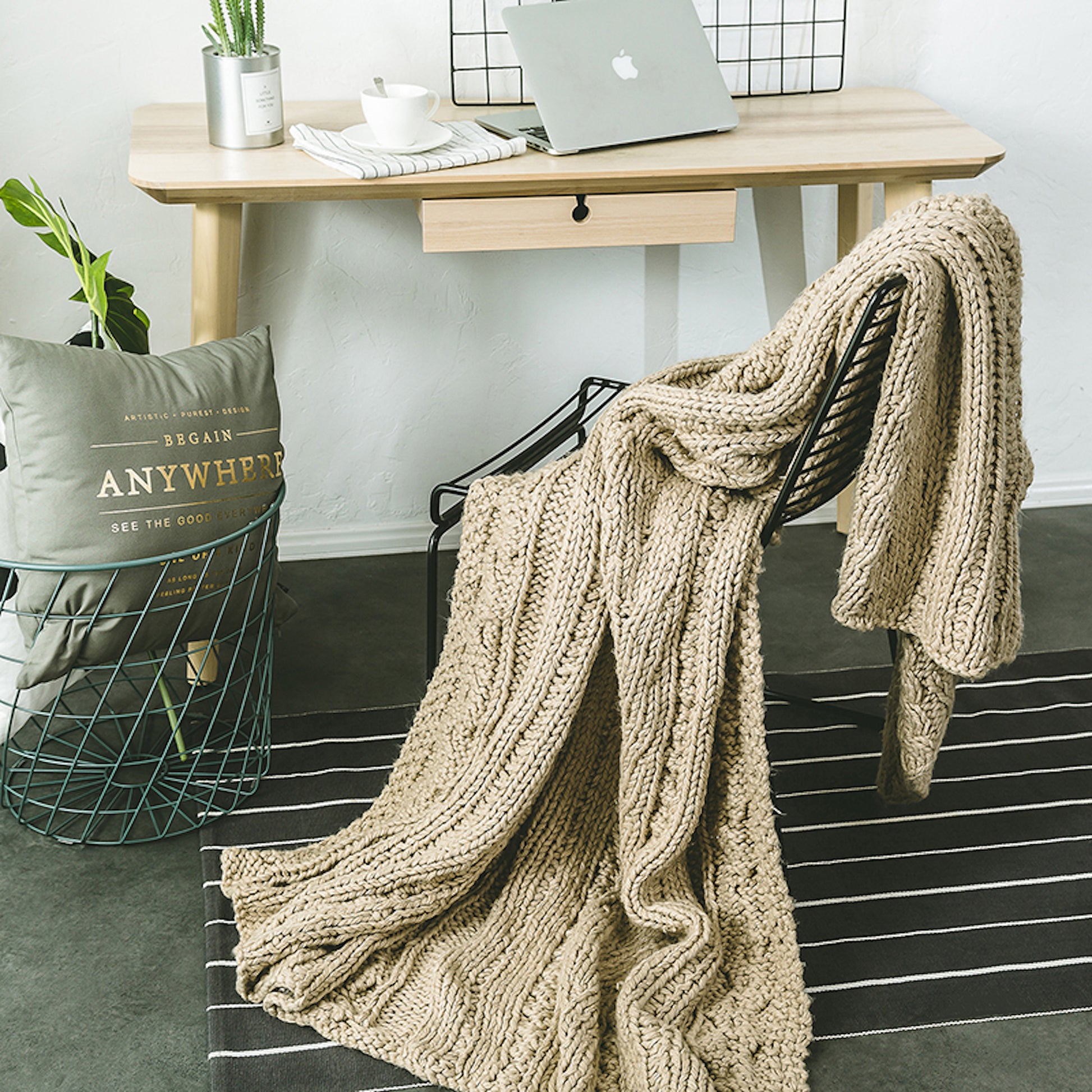 Khaki knitted throw blanket draping on a chair