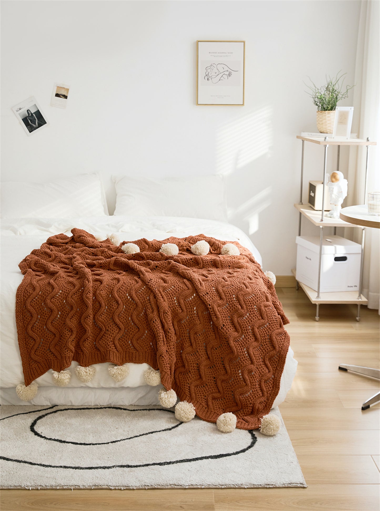 Rusty Orange Pompom Fringes Solid Chenille Knitted Throw Blanket on a bed