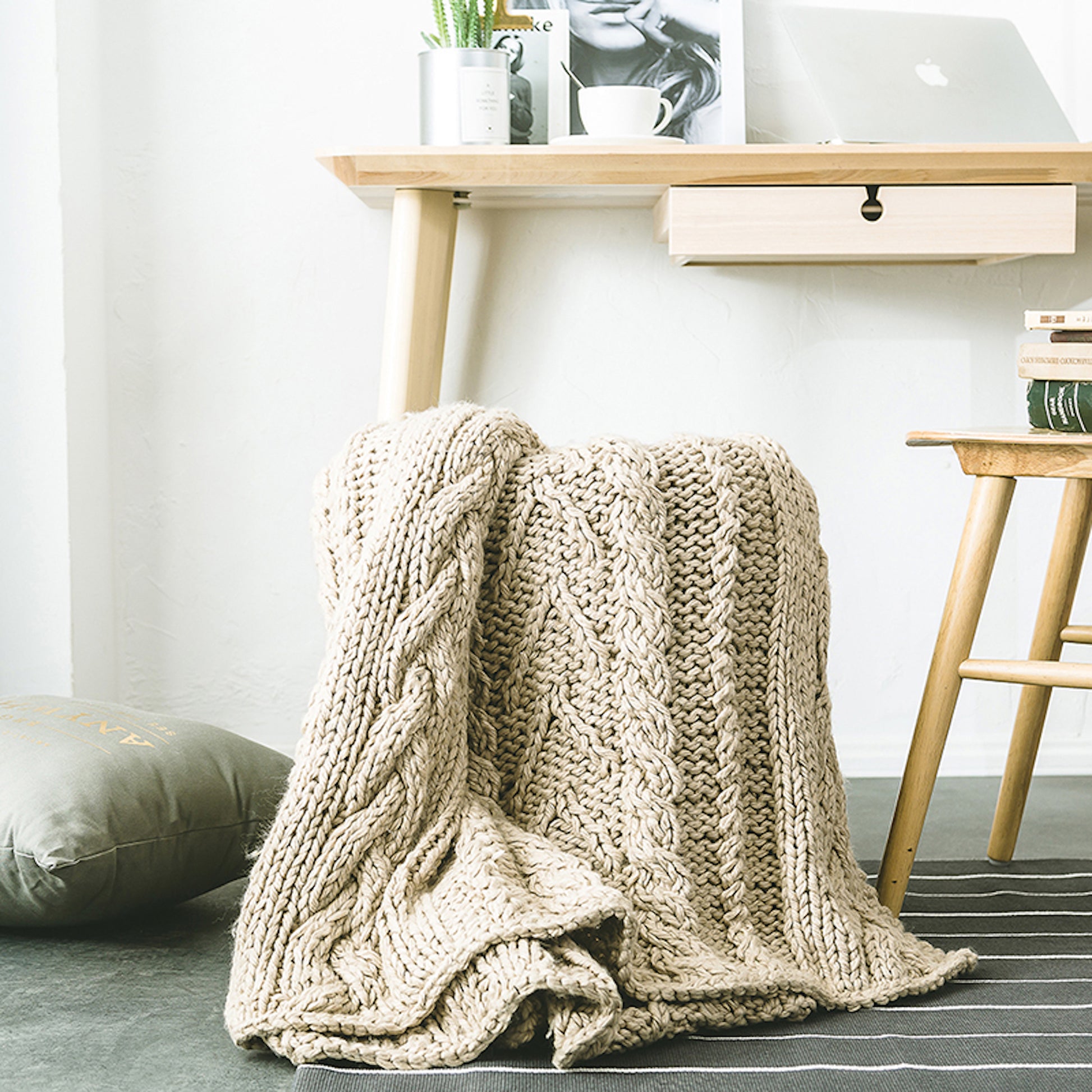 Beige Knitted Throw Blanket draping over a chair