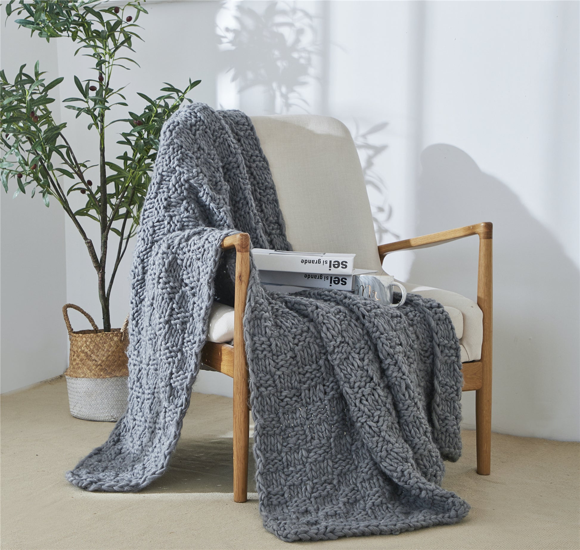 Iceland Yarn Dark Gray Thick Knitted Throw Blanket on a chair