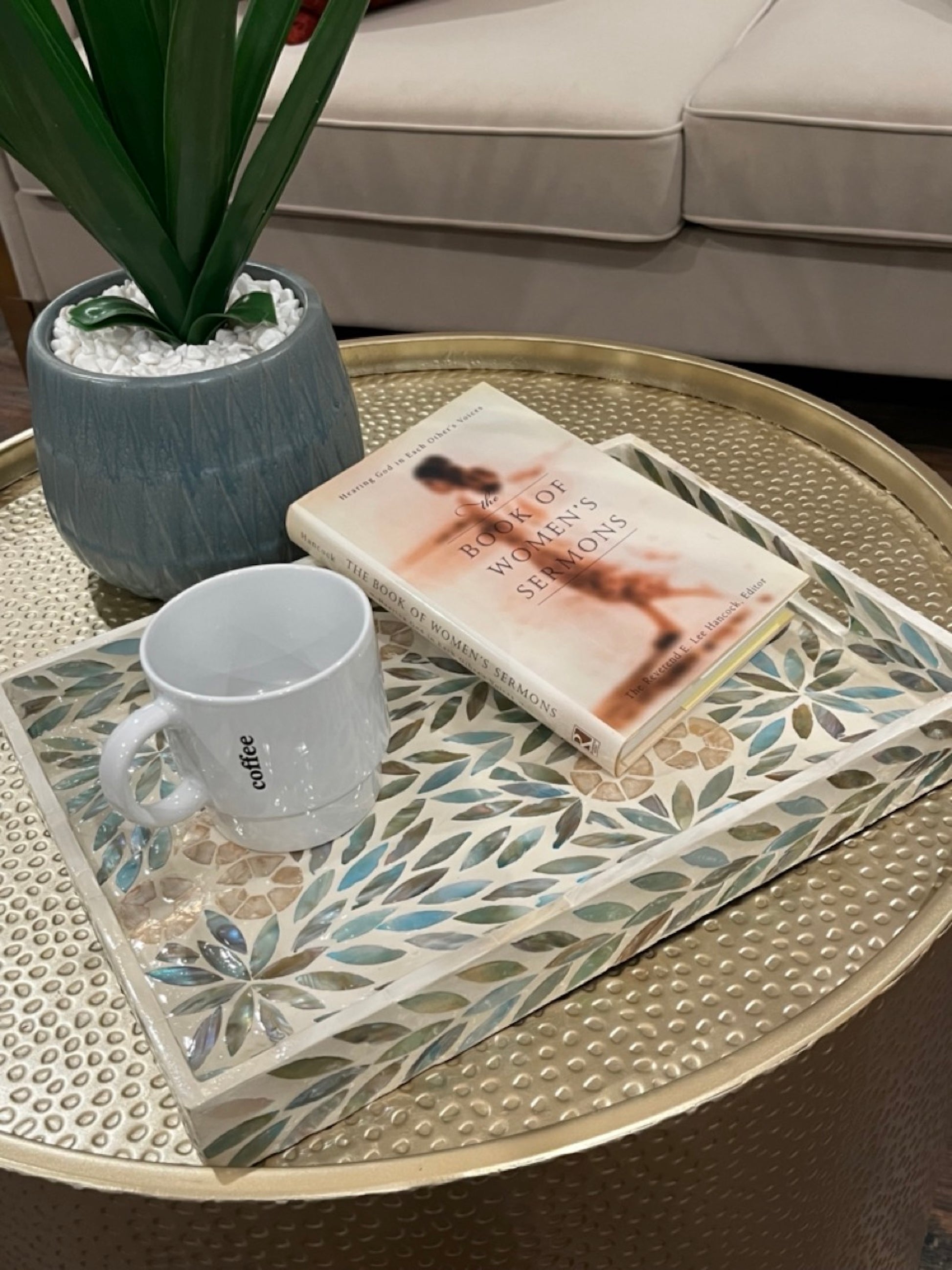 Turquoise Rectangle Flower Pattern Mother of Pearl Tray on the living room table with a cup and a book