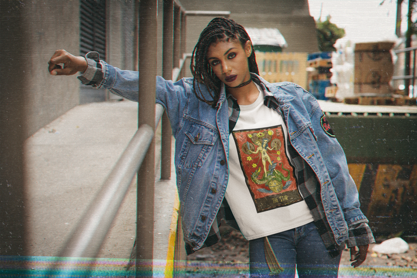 A woman wearing a white The Star Tarot Card T-Shirt, a checkered long sleeve collar shirt, denim jacket, and blue jeans