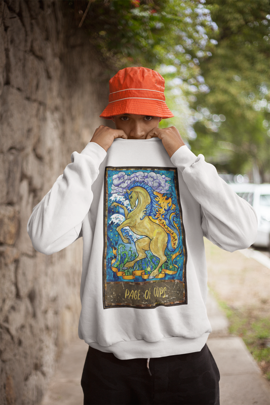 A man wearing an orange bucket hat, a white Page of Cups Tarot Card Sweatshirt, and black pants