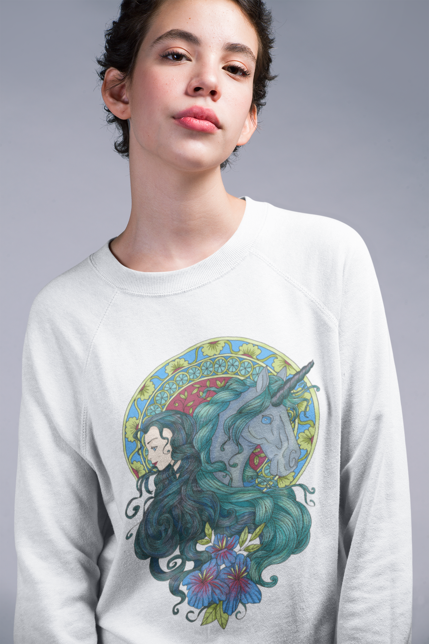 A woman with short hair wearing a white Caribbean Current Princess and Magic Unicorn Sweatshirt