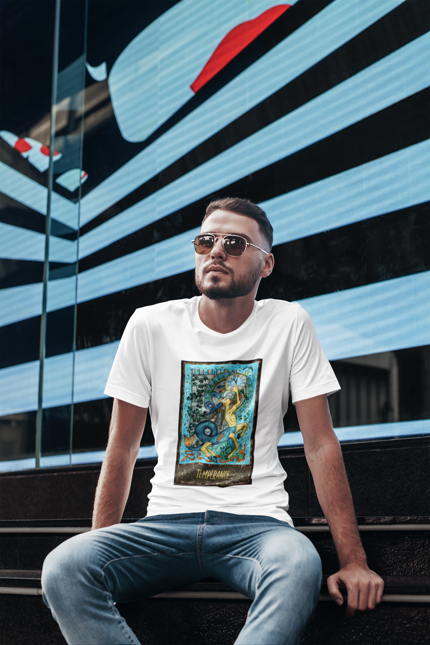 A man with sunglasses wearing a white Temperance Tarot Card T-shirt and jeans