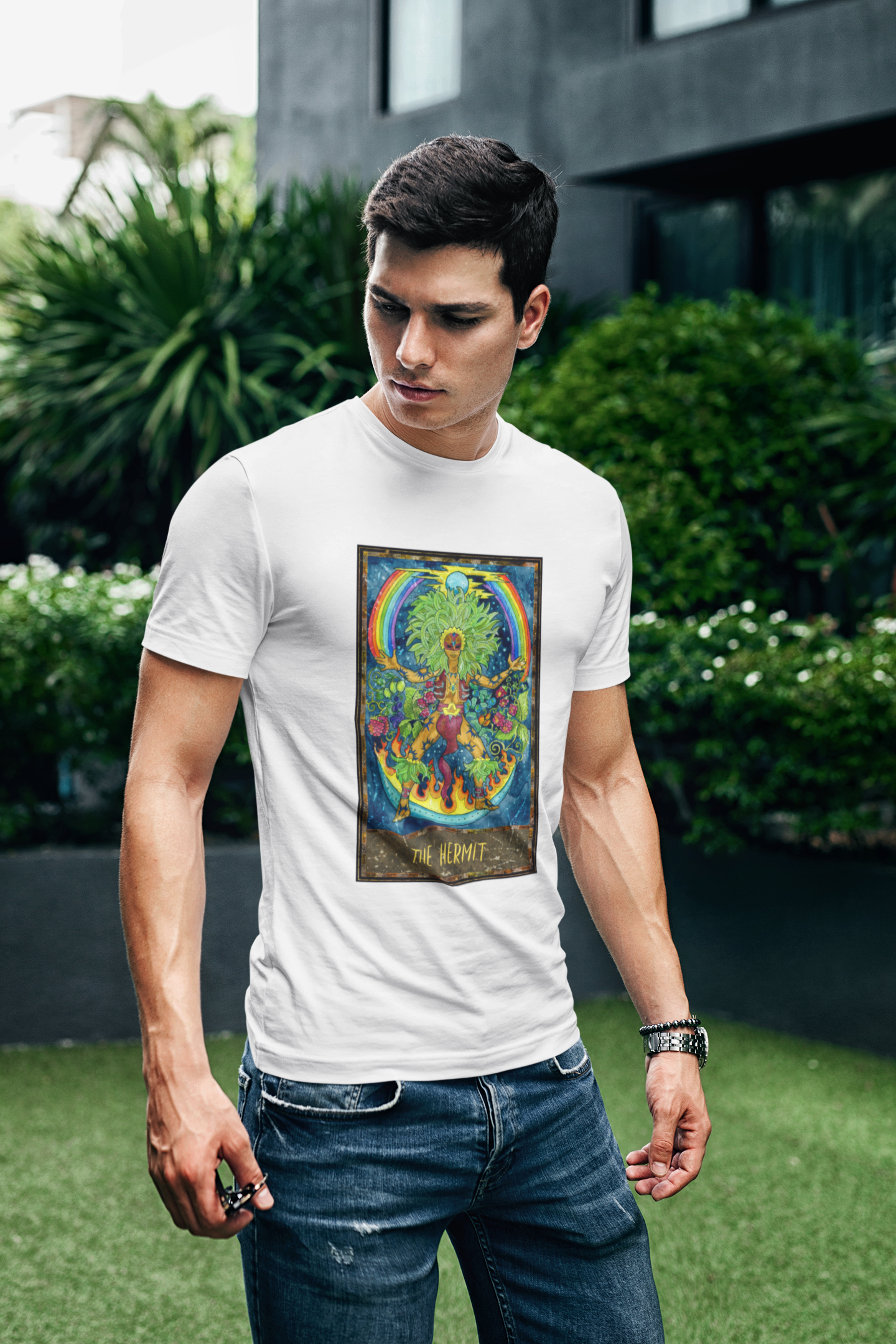 A man wearing a white The Hermit Tarot Card T-shirt and dark blue jeans