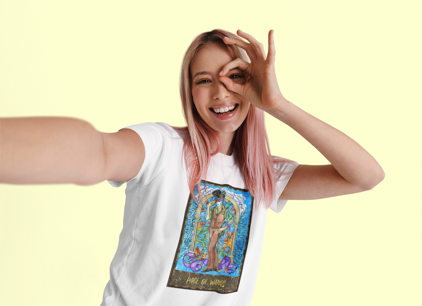 A pink haired woman posing for a selfie wearing a white Page of Wands Tarot Card T-shirt