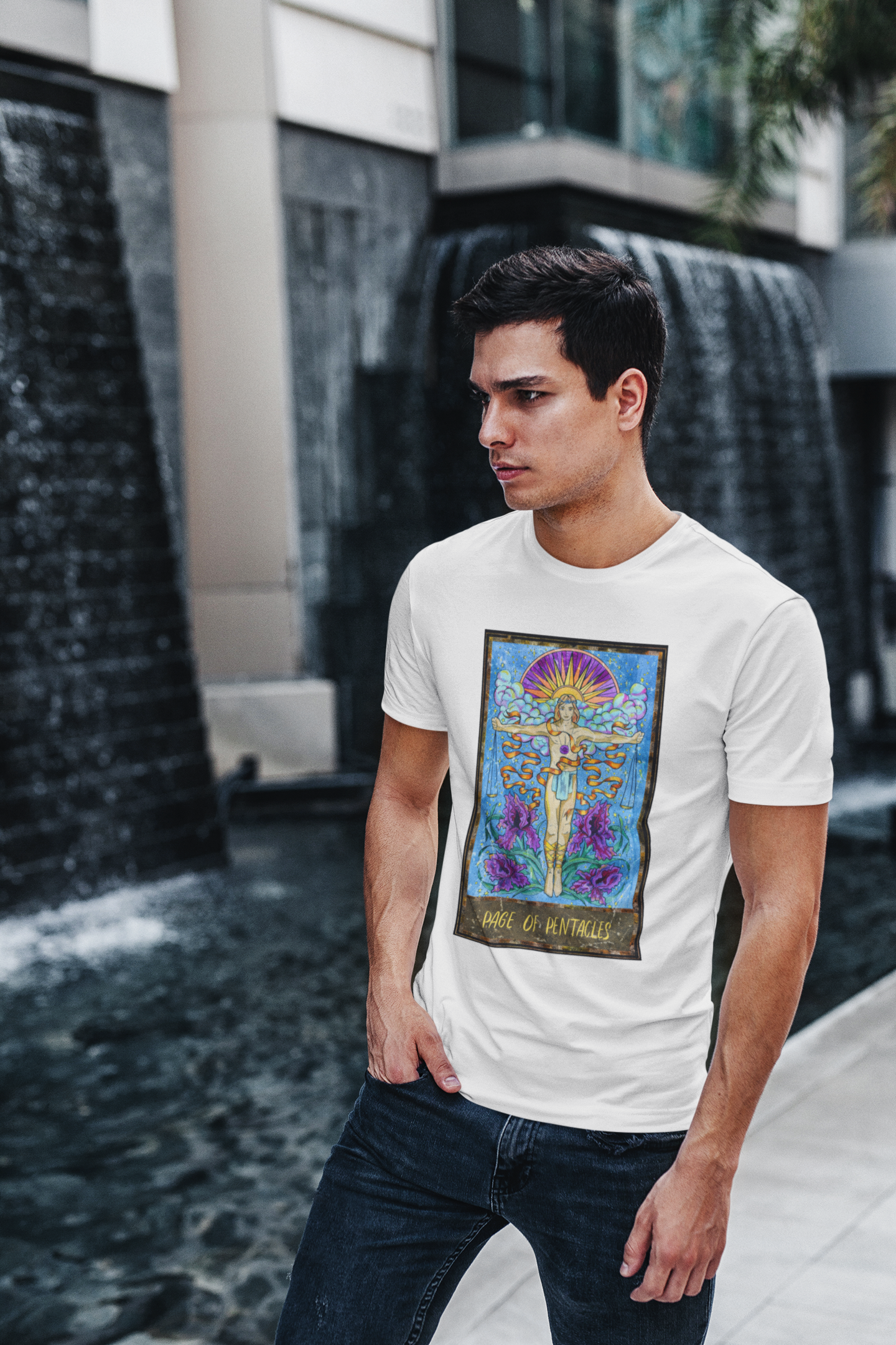 A man wearing a white Page of Pentacles Tarot Card T-shirt and blue jeans