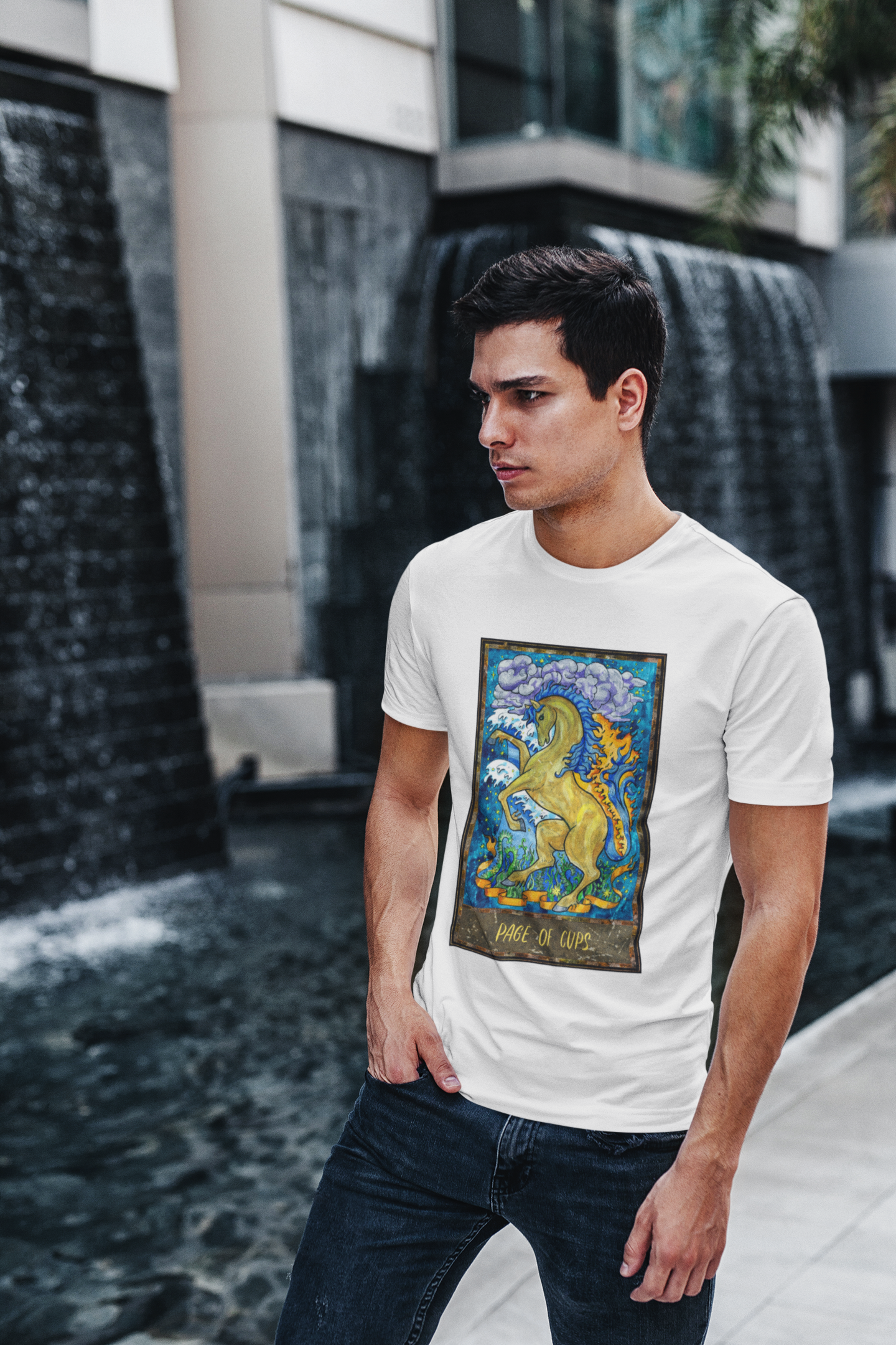 A man wearing a white Page of Cups Tarot Card T-shirt and jeans