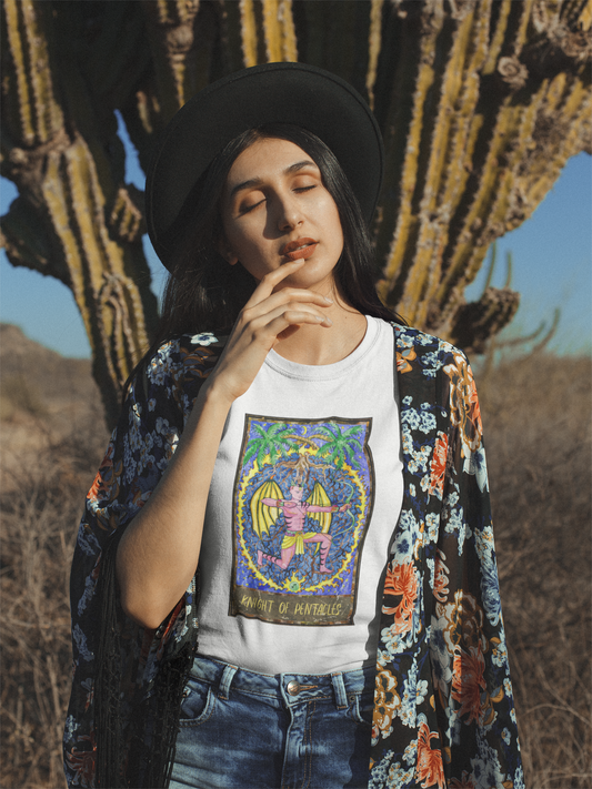 A hipster girl posing against a cactus plant wearing a black hat, a white Knight of Pentacles Tarot Card T-shirt, a flower kimono jacket, and blue jeans