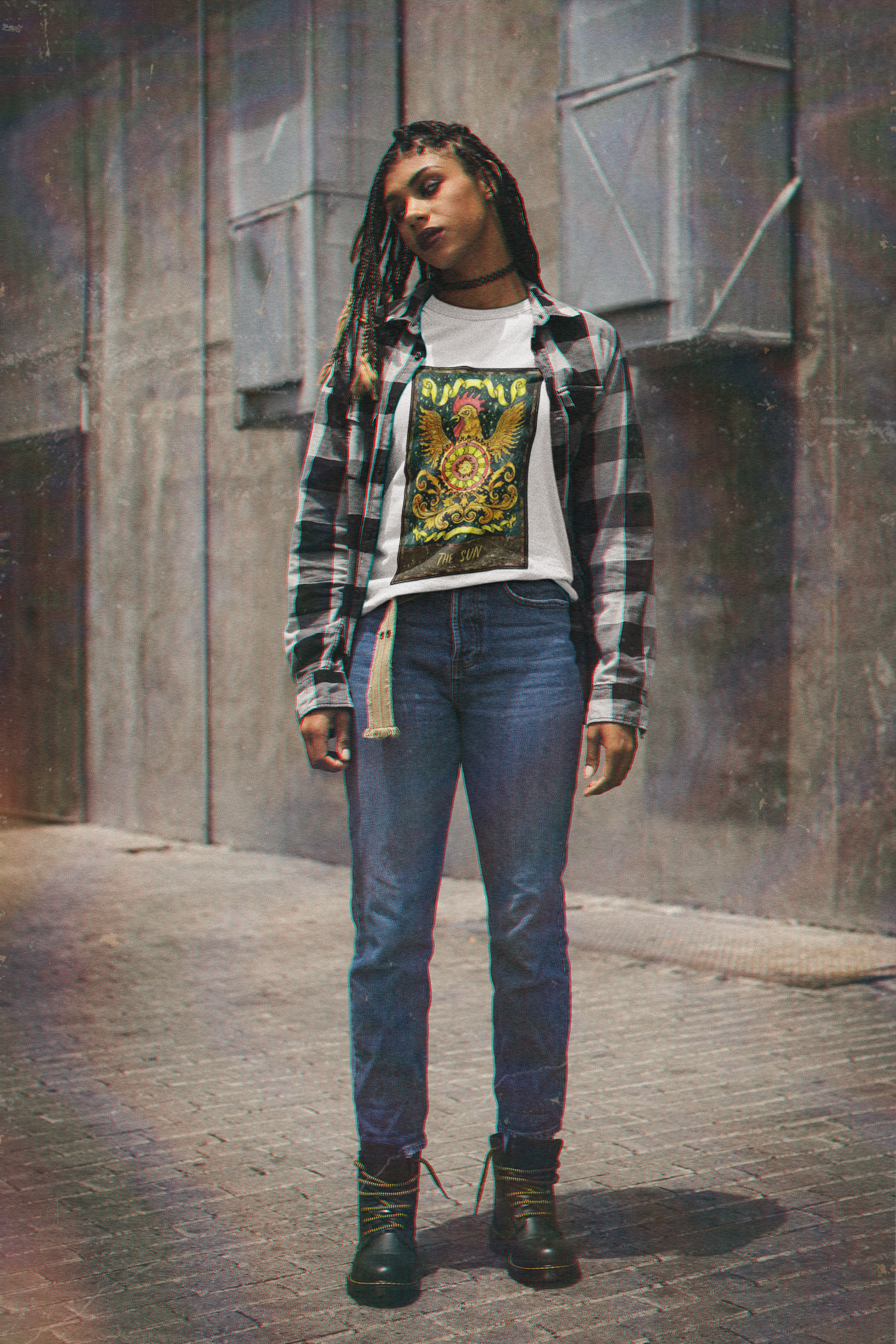 A woman wearing a white The Sun Tarot Card T-Shirt inside a collar shirt, blue jeans and black boots