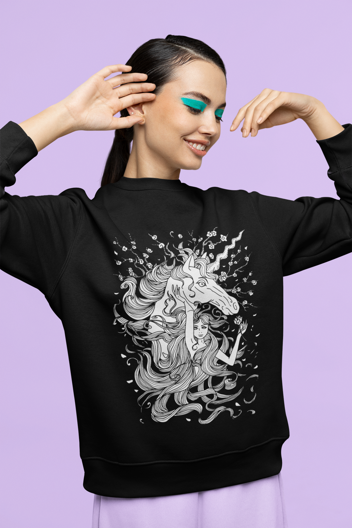 A smiling woman with blue eye-shadow wearing a black Line Art Walnut Brown Princess and Magic Unicorn Sweatshirt