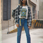 A woman with sunglasses wearing a white The World Tarot Card T-Shirt, collar outer shirt, blue jeans and black boots